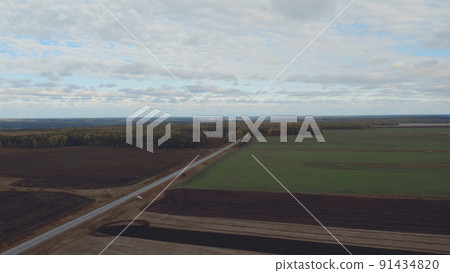 Green and brown rural fields with blue sky in autumn time in Ural 91434820