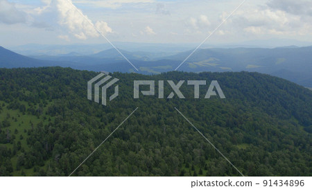 Green forest on mountains of Manzherok under white clouds Green forest on mountains of Manzherok under white clouds 91434896