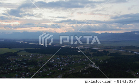 Aerial view of valley and country houses under blue sky in sunset time 91435057