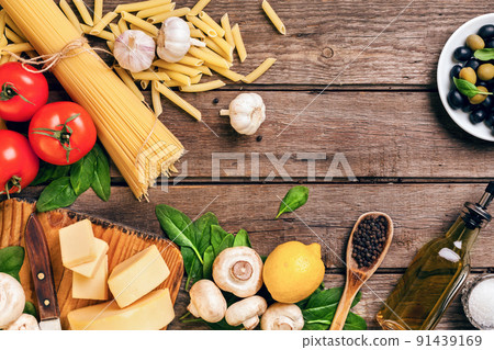 Ingredients for spaghetti with basil, tomatoes, cheese on wooden background, top view, place for text Ingredients for spaghetti with basil, tomatoes, cheese on wooden background, top view, place for text 91439169