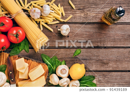 Ingredients for spaghetti with basil, tomatoes, cheese on wooden background, top view, place for text Ingredients for spaghetti with basil, tomatoes, cheese on wooden background, top view, place for text 91439189