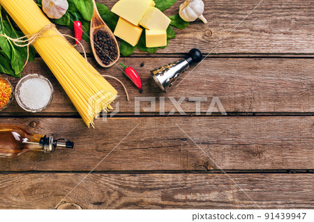 Pasta and ingredients on wooden background with copy space. Top view. Vegetarian food, healthy or cooking concept. 91439947