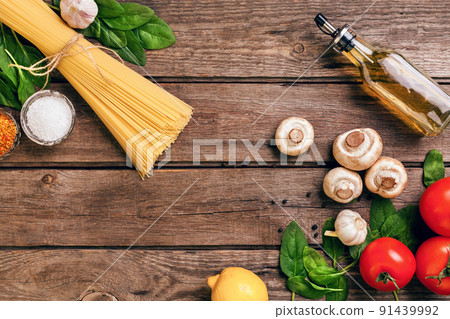 Pasta ingredients - tomatoes, olive oil, garlic, italian herbs, fresh basil, salt and spaghetti on a wooden background with copy space, horizontal, top view Pasta ingredients - tomatoes, olive oil, garlic, italian herbs, fresh basil, salt and spaghetti on a wooden background with copy space, horizontal, top view 91439992