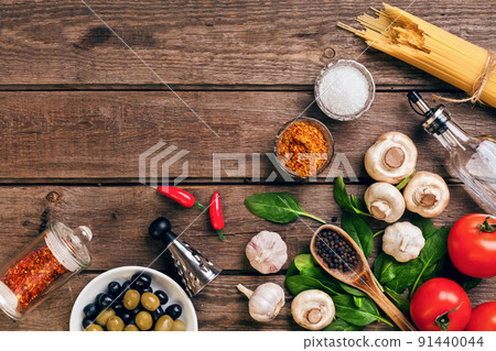 Pasta ingredients - tomatoes, olive oil, garlic, italian herbs, fresh basil, salt and spaghetti on a wooden background with copy space, horizontal, top view Pasta ingredients - tomatoes, olive oil, garlic, italian herbs, fresh basil, salt and spaghetti on a wooden background with copy space, horizontal, top view 91440044