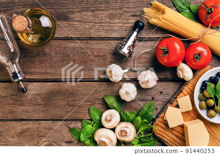 Italian food background with pasta, spices and vegetables. Top view, copy space. Italian food background with pasta, spices and vegetables. Top view, copy space. 91440253