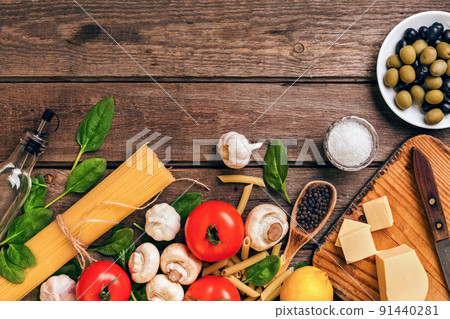 Italian food background with pasta, spices and vegetables. Top view, copy space. Italian food background with pasta, spices and vegetables. Top view, copy space. 91440281