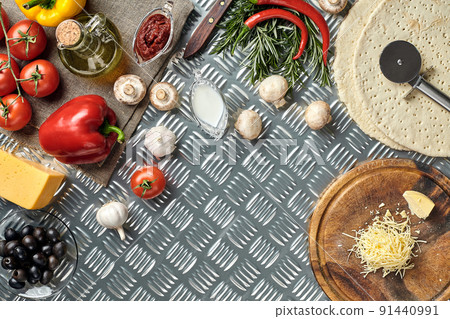 Cheese, different vegetables on metal table. Ingredients for traditional italian pizza. 91440991