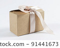 cardboard holiday box with pink ribbon. packaging example. 91441673
