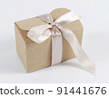 cardboard holiday box with pink ribbon. packaging example 91441676