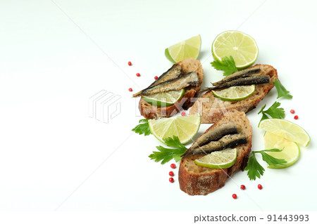 Delicious sandwiches with sprats on white background 91443993