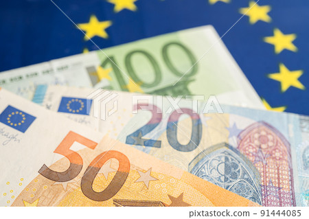 Euro banknotes on EU flag, finance and accounting, banking concept. Euro banknotes on EU flag, finance and accounting, banking concept. 91444085