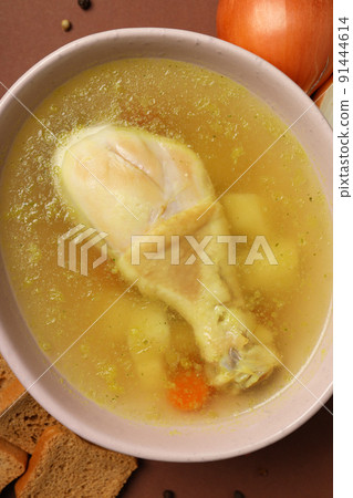 Concept of cooking chicken soup on brown background 91444614
