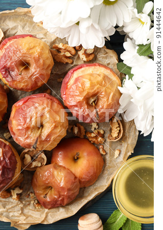 Concept of tasty food with baked apples on wooden background Concept of tasty food with baked apples on wooden background 91444642