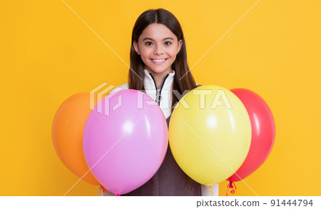 smiling kid with party colorful balloons on yellow background smiling kid with party colorful balloons on yellow background 91444794