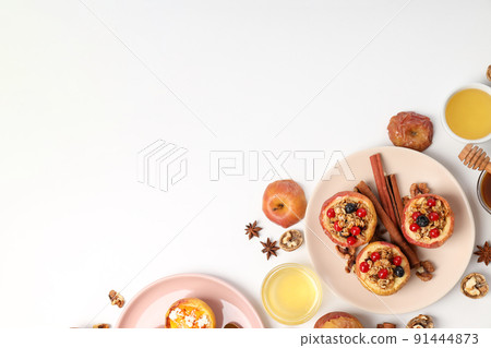 Concept of tasty food with baked apples on white background Concept of tasty food with baked apples on white background 91444873