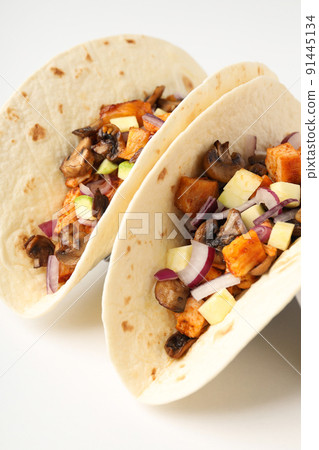 Concept of tasty food with taco on white background Concept of tasty food with taco on white background 91445134