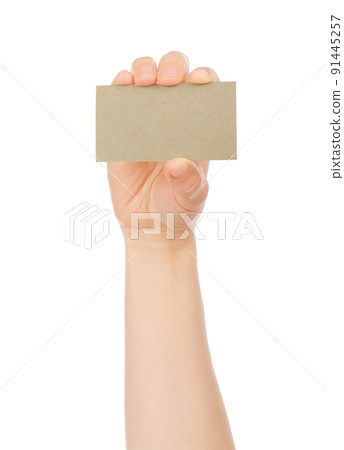 Hand holds blank business card on white background Hand holds blank business card on white background 91445257