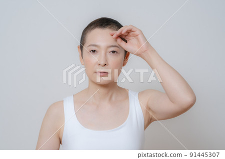 Portrait of middle age woman with very short hairstyle Portrait of middle age woman with very short hairstyle 91445307