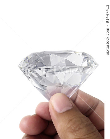 Diamond jewel in hand, isolated on white background 91447412