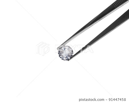 Diamond on white background held in diamond tweezers Diamond on white background held in diamond tweezers 91447458