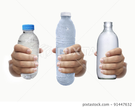 Bottle of water in hand isolated on white background Bottle of water in hand isolated on white background 91447632