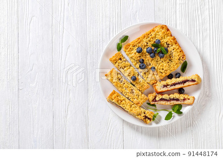 sliced blueberry crumble pie on plate, top view sliced blueberry crumble pie on plate, top view 91448174