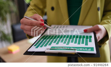 Businesswoman holds financial report and analytics in charts 91448264