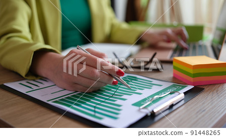Business woman working with documents at the table in office closeup Business woman working with documents at the table in office closeup 91448265