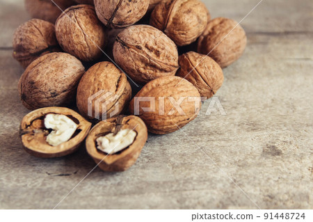 Walnuts in a round wicker basket on a wooden background. Place for your text Walnuts in a round wicker basket on a wooden background. Place for your text 91448724
