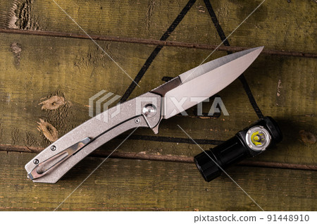 Pocket folding knife and flashlight. Knife with a clip for carrying. Metal handle and clip. EDC. Pocket folding knife and flashlight. Knife with a clip for carrying. Metal handle and clip. EDC. 91448910