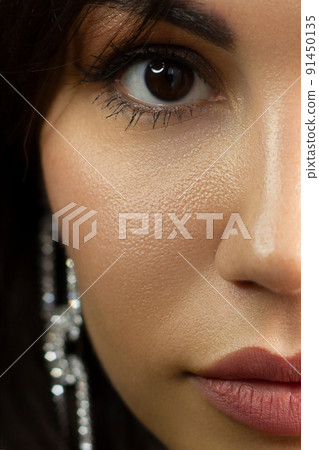 Half a beauty portrait with beautiful fashionable evening make-up, red liner on eyes and extremely long eyelashes. Pink lipstick on the lips. Cosmetology and spa facial skin care Half a beauty portrait with beautiful fashionable evening make-up, red liner on eyes and extremely long eyelashes. Pink lipstick on the lips. Cosmetology and spa facial skin care 91450135