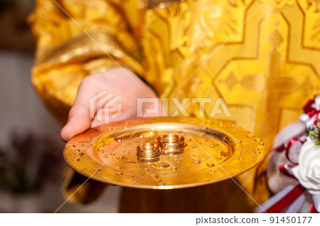 Gold wedding rings on the gold plate in the church Gold wedding rings on the gold plate in the church 91450177