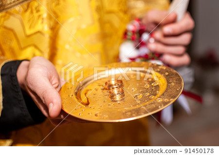Gold wedding rings on the gold plate in the church Gold wedding rings on the gold plate in the church 91450178