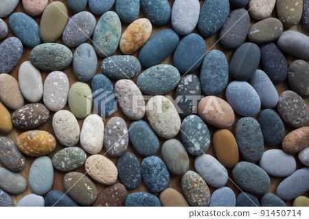 Colored blue and yellow sea stones background. Top view 91450714