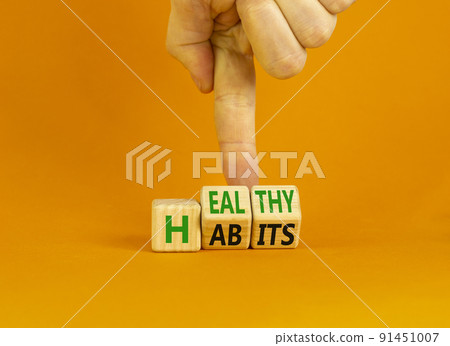 Healthy habits symbol. Concept words Healthy habits on wooden cubes. Doctor hand. Beautiful orange table orange background. Medical and healthy habits concept. Copy space. Healthy habits symbol. Concept words Healthy habits on wooden cubes. Doctor hand. Beautiful orange table orange background. Medical and healthy habits concept. Copy space. 91451007