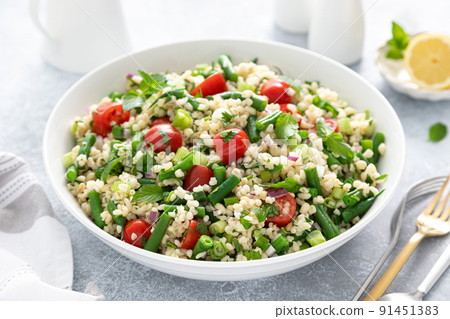 Tabbouleh salad. Tabouli salad with fresh parsley, onions, tomatoes, bulgur and green beans. Healthy vegetarian food, diet Tabbouleh salad. Tabouli salad with fresh parsley, onions, tomatoes, bulgur and green beans. Healthy vegetarian food, diet 91451383