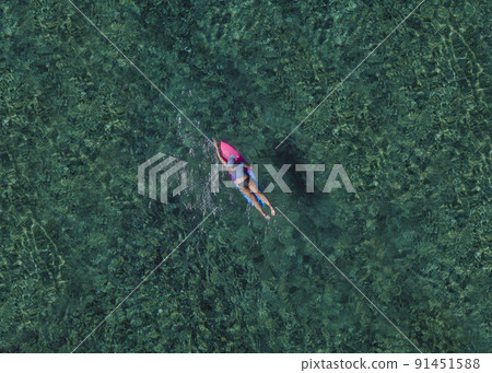 Female surfer in Indian Ocean Female surfer in Indian Ocean 91451588