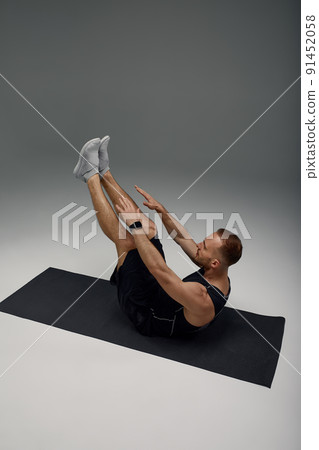 Male Morning Workout. Sporty Man Doing Sit-Ups Abs Exercise On Gymnastics Mat Training And Working Out. Fitness Lifestyle Motivation, Stay Fit Concept Male Morning Workout. Sporty Man Doing Sit-Ups Abs Exercise On Gymnastics Mat Training And Working Out. Fitness Lifestyle Motivation, Stay Fit Concept 91452058