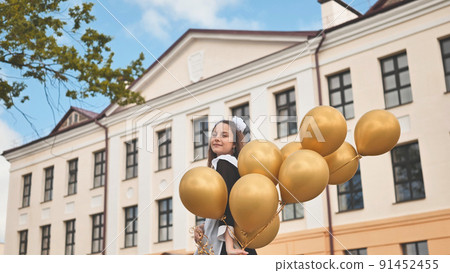 Happy Russian schoolgirl on the last day of school with balloons. 91452455