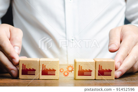 Businessman arranges work between factory productions. Industrial conglomerates and economic clusters. Collaboration and communication when working on large projects. Business globalization 91452596