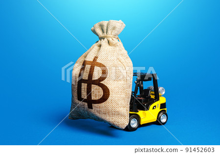 A forklift carrying a thai baht money bag. Borrowing on capital market. Strong financial assistance, business support. Investments. Subsidies soft loans. Anti crisis budget. Stimulating economy. 91452603