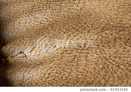 Focus stack macro of cracked faux leather on furniture with visible damage. Focus stack macro of cracked faux leather on furniture with visible damage. 91453392