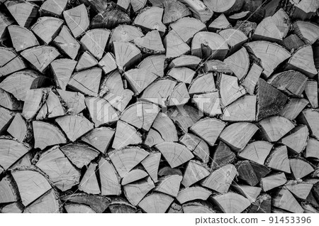 Stacked dry split wood for heating in a northern cold climate. 91453396