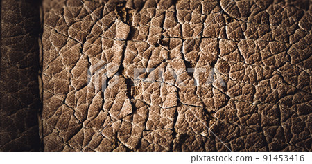 Focus stack macro of cracked faux leather on furniture with visible damage. Focus stack macro of cracked faux leather on furniture with visible damage. 91453416