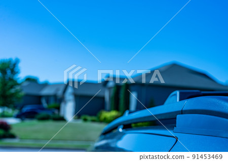 Narrow selective focus on the roof rack with cross bars installed on top of a vehicle 91453469