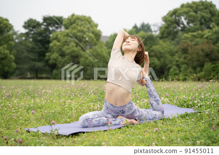 Park yoga half pigeon pose Park yoga half pigeon pose 91455011