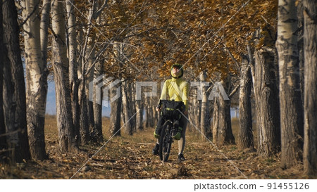 The woman travel on mixed terrain cycle touring with bikepacking. The traveler journey with bicycle bags. Sport tourism bikepacking. 91455126