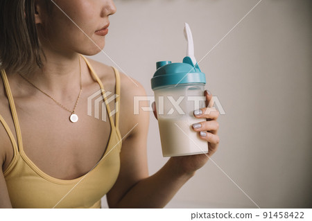Young woman drinking protein 91458422