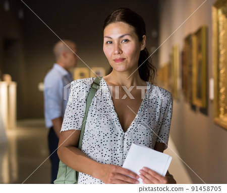 woman admiring art work 91458705