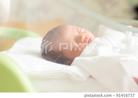 Newborn sleeping in a baby cot Newborn sleeping in a baby cot 91458737